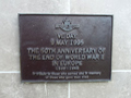 Bronze plaque with text under heading VE Day 9 August 1995
