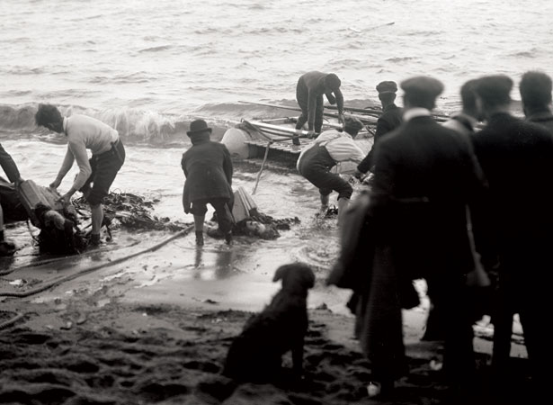 Hauling wreckage and a body ashore at Cape Terawhiti