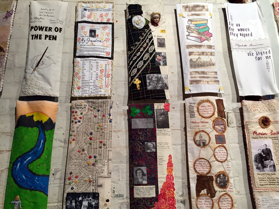 Mosaic of stitched panels with women's suffrage messages