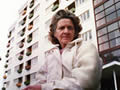 Woman in front of block of flats