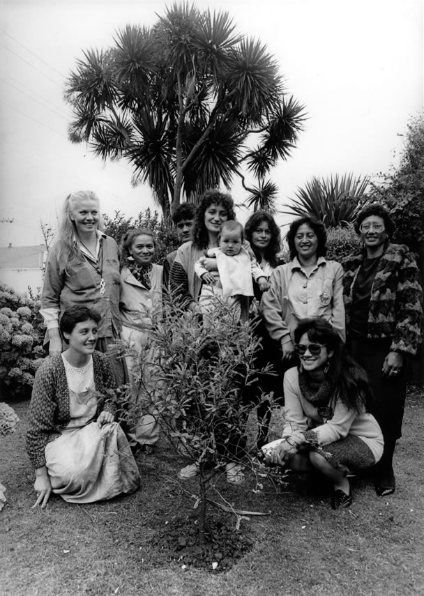 Women gathered in front of tree