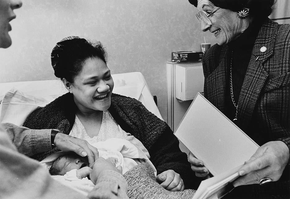Altrusa members presenting baby with a book