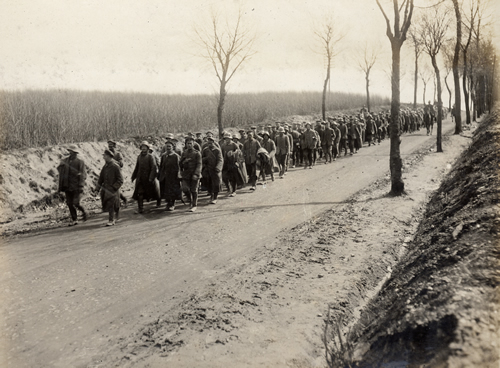 Soliders marching pows along sunken road