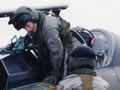 Dame Cath Tizard climbing into an airforce aircraft