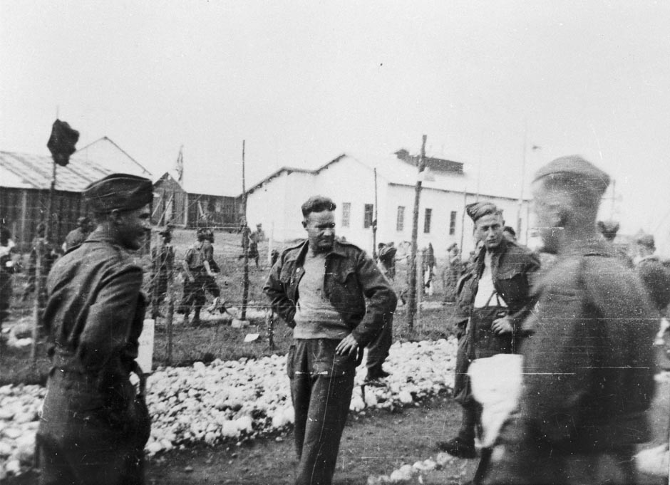 prisoners walking outside the wire