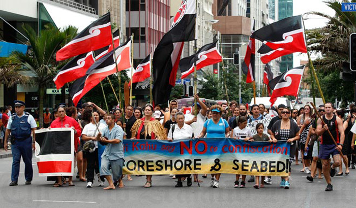 Tino rangatiratanga flags, symbolising Māori self-determination, fly above foreshore and seabed hīkoi (march) along Auckland's Queen Street in March 2011