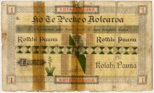 Worn and creased bank note with te reo Māori writing on it.