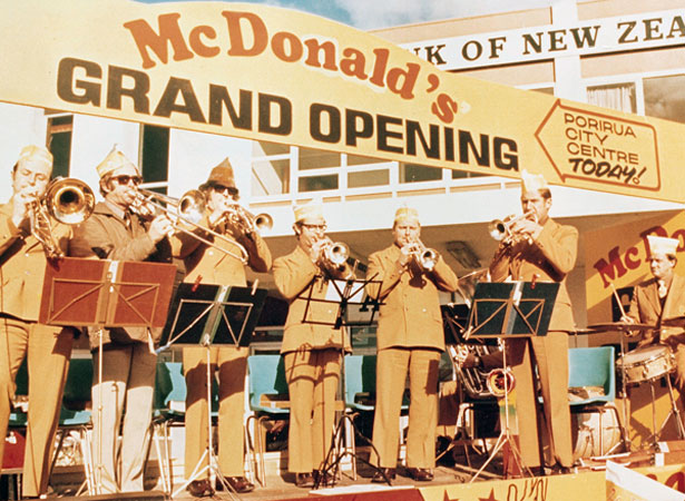Brass band playing under 'McDonald's Grand Opening' sign