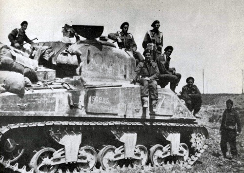 18 Battalion infantrymen on an M4 Sherman tank