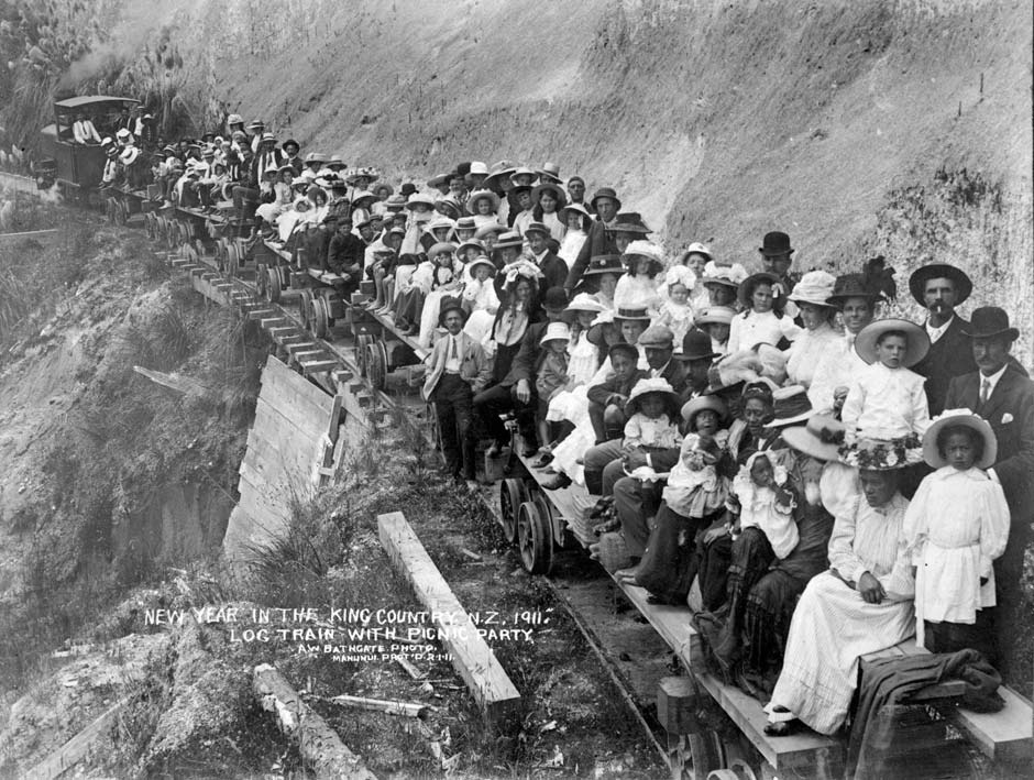 Logging train with picnic party, 1911