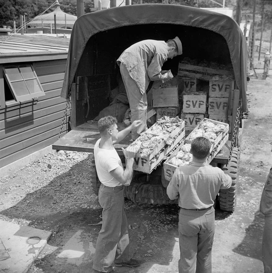 Unloading vegetables at US camp