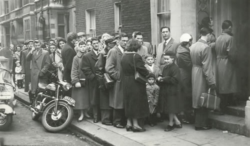 Queues of immigrants in London