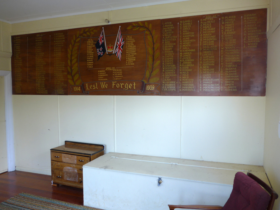 Wooden plaque fixed on a wall with lists of names in gold lettering
