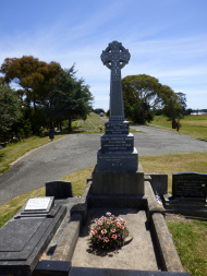 Front view of gravestone with Celtic cross at the top
