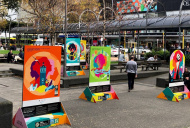 An urban park decorated with five large colourful posters.