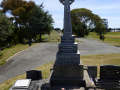 Front view of gravestone with Celtic cross at the top