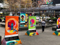 An urban park decorated with five large colourful posters.
