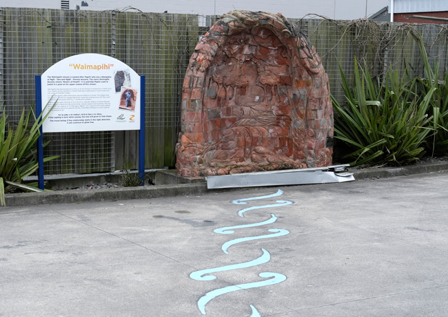 Waimapihi Stream artwork made from historic brick culvert next to information panel with text and historic photographs