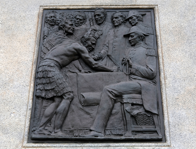 Detail of bronze relief on Queen Victoria statue showing Māori and European figures signing document