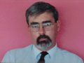 Work identification card of Bill Simpson showing bearded man with glasses in shirt and tie