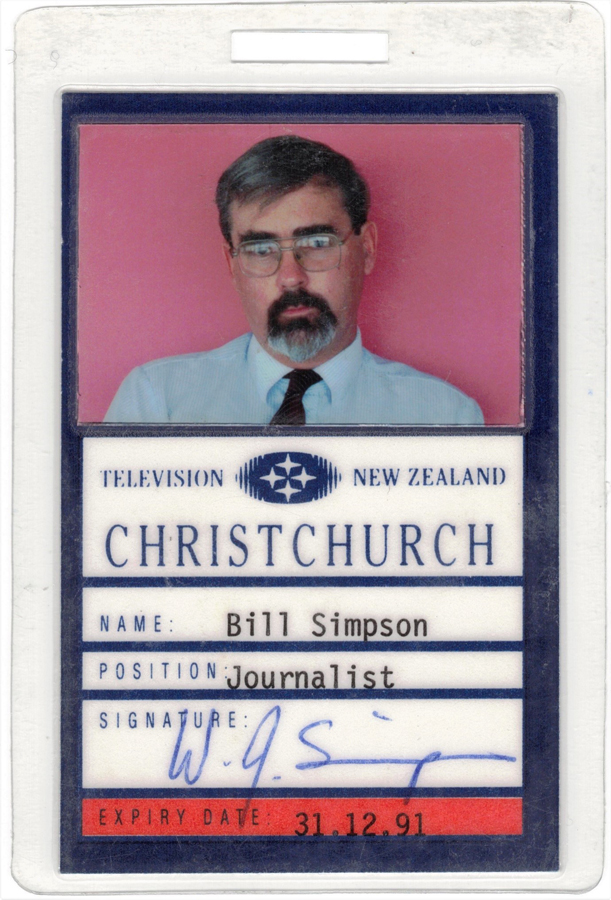 Identification card featuring text and picture of a bearded man with glasses in shirt and tie