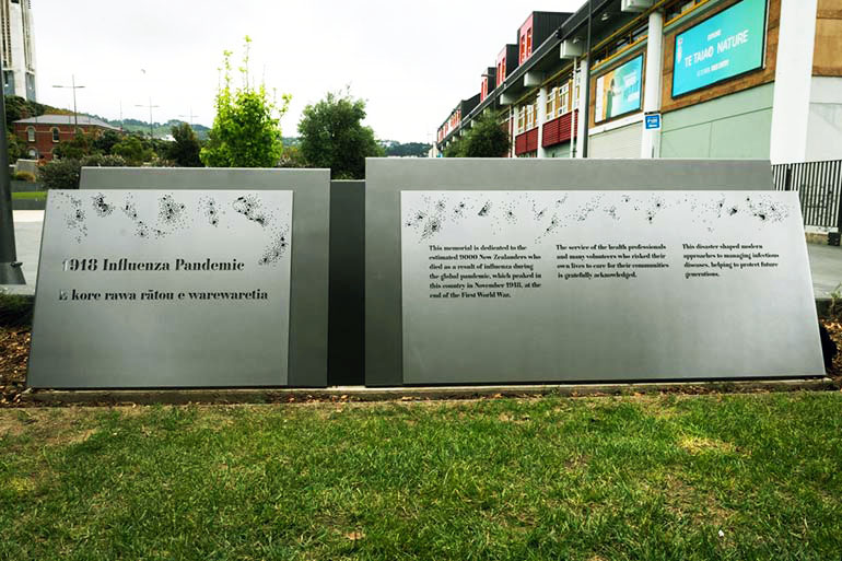 Steel plaque inscribed with text sitting on grass
