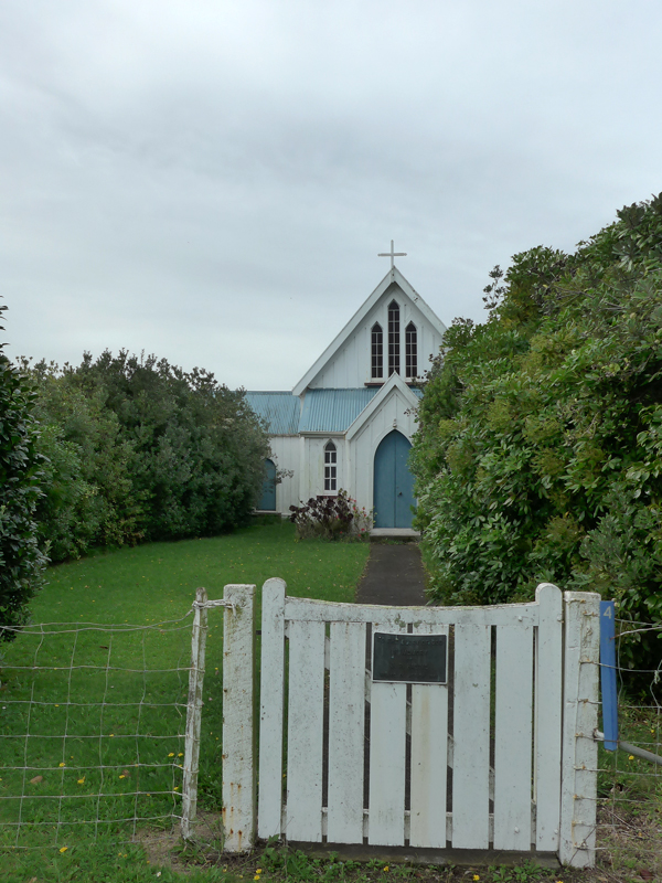 Wooden gate and path leading to wooden Church building 