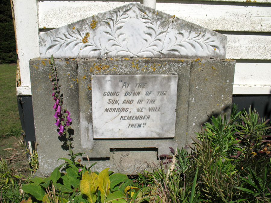 Plaque with writing inlaid at the bottom of a church building
