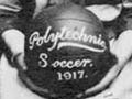 Group of women in uniform, one holding a ball.