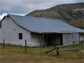 Single storey house with white plaster walls and overhanging roof