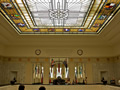 Stained glass ceiling window of room with names on walls and several flags, including Union Jack and New Zealand Flag