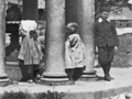 Three young children at a memorial built with Roman columns