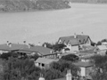 Looking down on village across to a bay surrounded by bare hills