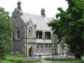 Tw-story stone building set in beautiful garden