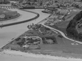 Aerial view of memorial in relation to nearby river mouth and hills