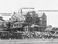 Large wooden building behind Cricket grounds