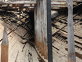 Wooden struts supported by metal poles under deck
