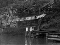 Remains of ship moored against wharf