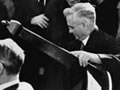 Prime Minister Savage carrying a table through crowd