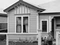 Victorian villa with two children in front