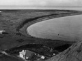 Bay with bare ground an a few houses