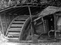 Ruins of water wheel in open shed