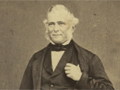Middle-aged man in  three piece suit and bow tie