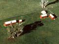 Aerial view of buildings in paddock next to ocean