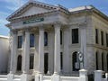 Columned Greek style building with 'The National Bank' sign on front
