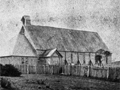 Historic image of plain wooden church building in field