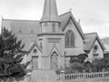 Church with spire with harbour in the background