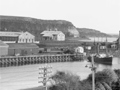 Historic image of harbour and wharf with factory buildings
