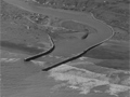 Harbour entrance with long walls on each side reaching into the ocean