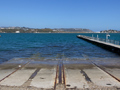 Concrete panels with rail lines partially submerged in harbour